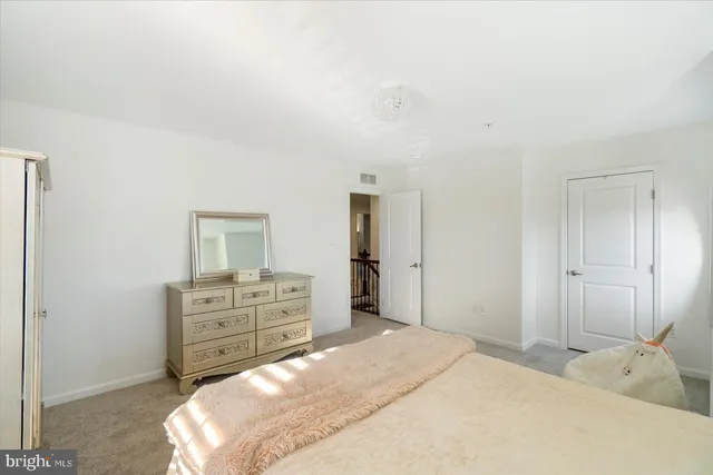 a bedroom with a bed and cabinet