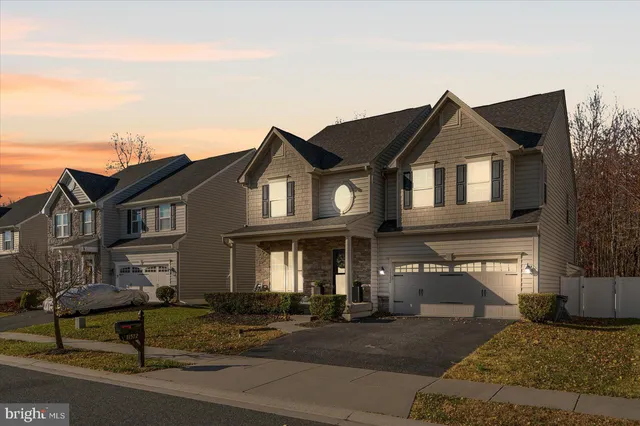 a front view of a house with swimming pool and porch