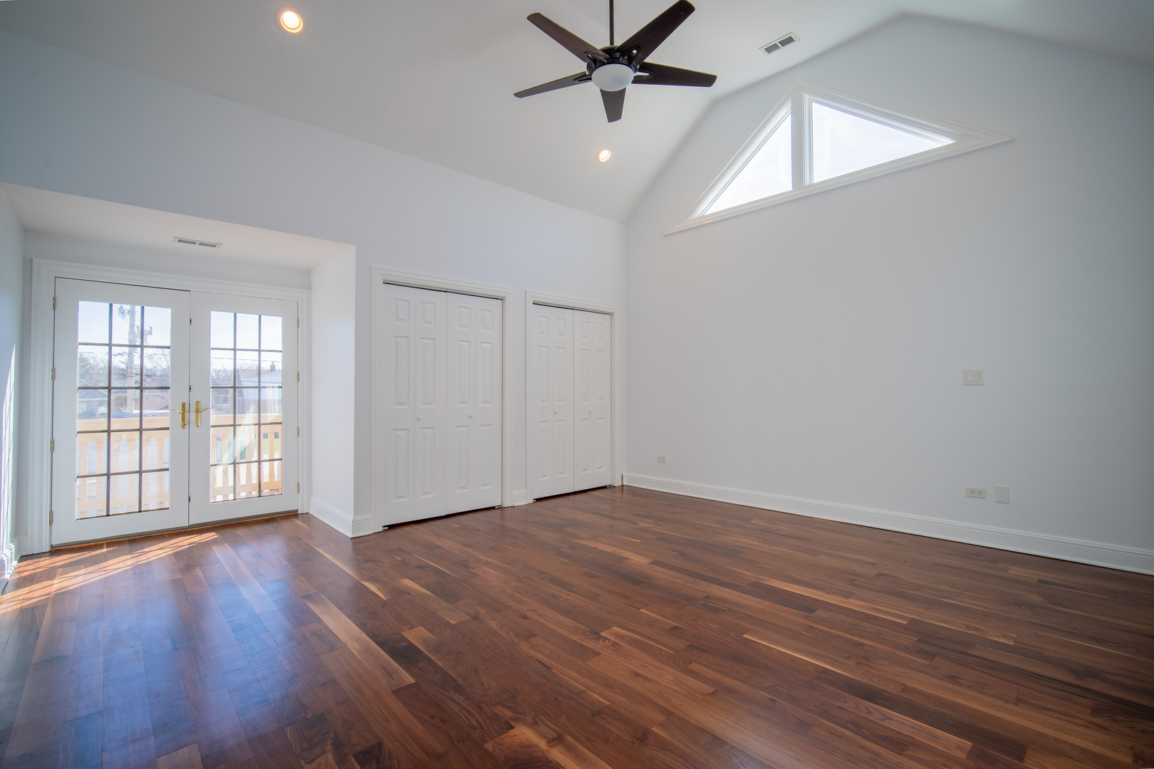 4137 Clinton Avenue Stickney, IL 60402 - Photo 22 of 41 an empty room with wooden floor fan and windows