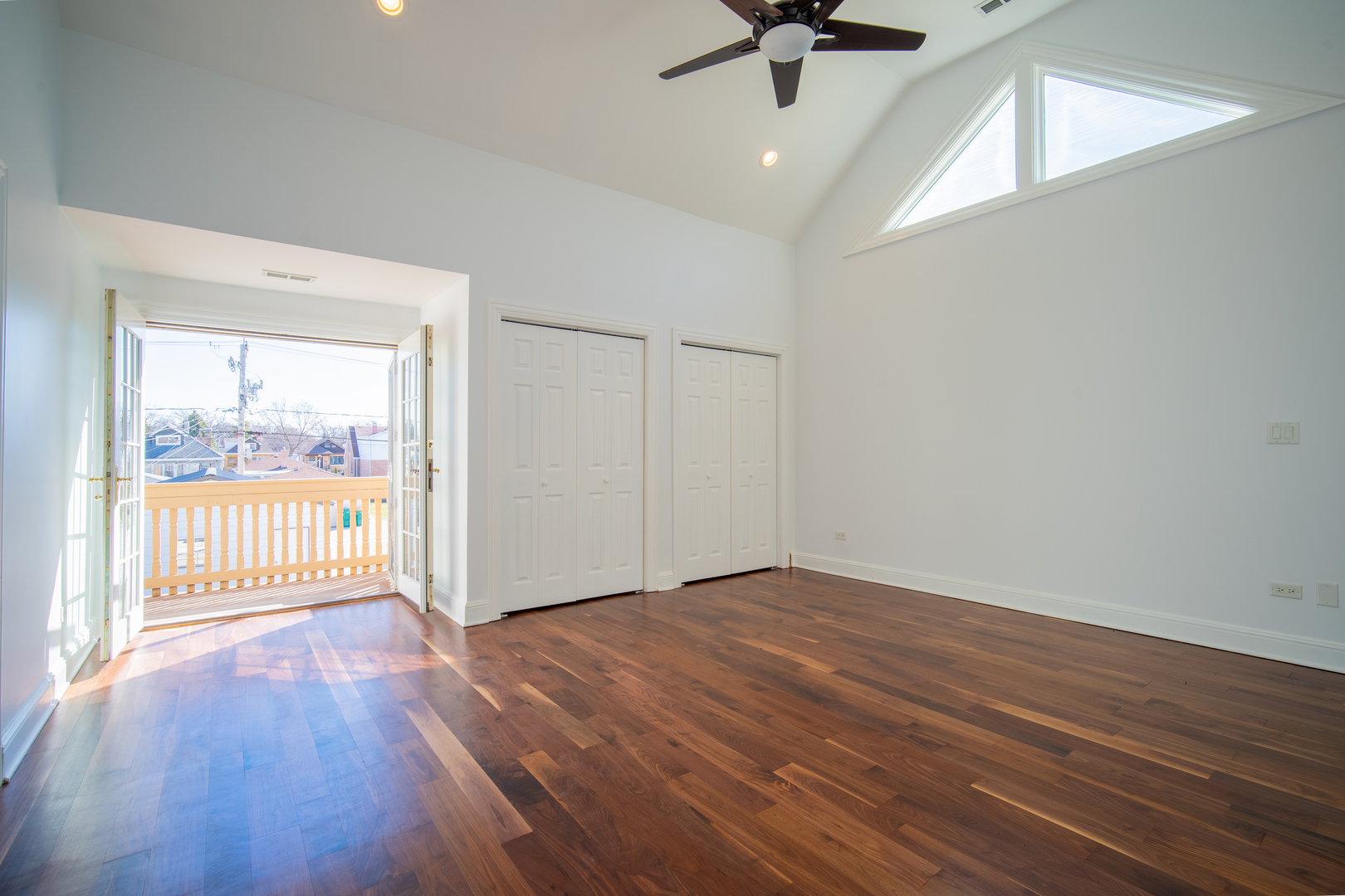 4137 Clinton Avenue Stickney, IL 60402 - Photo 23 of 41 an empty room with wooden floor fan and windows