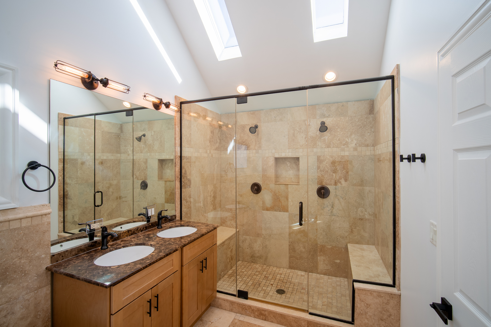 4137 Clinton Avenue Stickney, IL 60402 - Photo 26 of 41 a bathroom with a granite countertop sink a mirror a glass door a shower and vanity