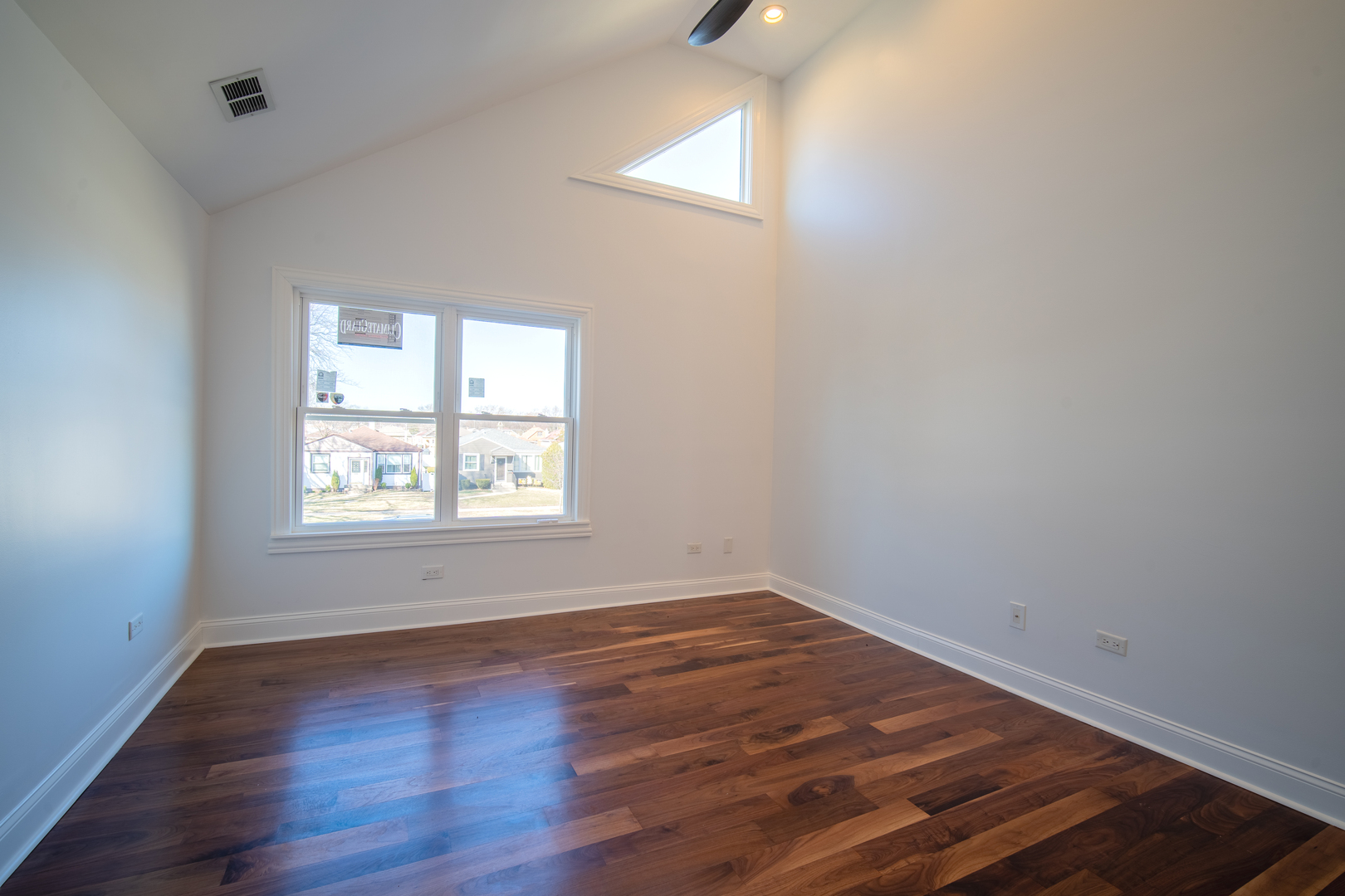 4137 Clinton Avenue Stickney, IL 60402 - Photo 29 of 41 an empty room with wooden floor and windows