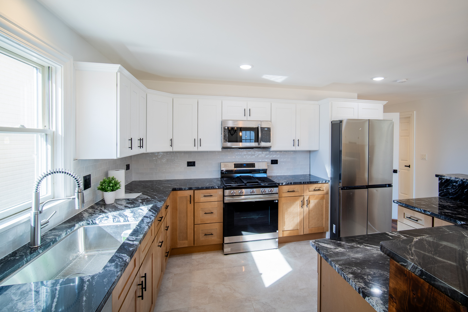 4137 Clinton Avenue Stickney, IL 60402 - Photo 3 of 41 a kitchen with stainless steel appliances granite countertop a stove refrigerator sink and cabinets