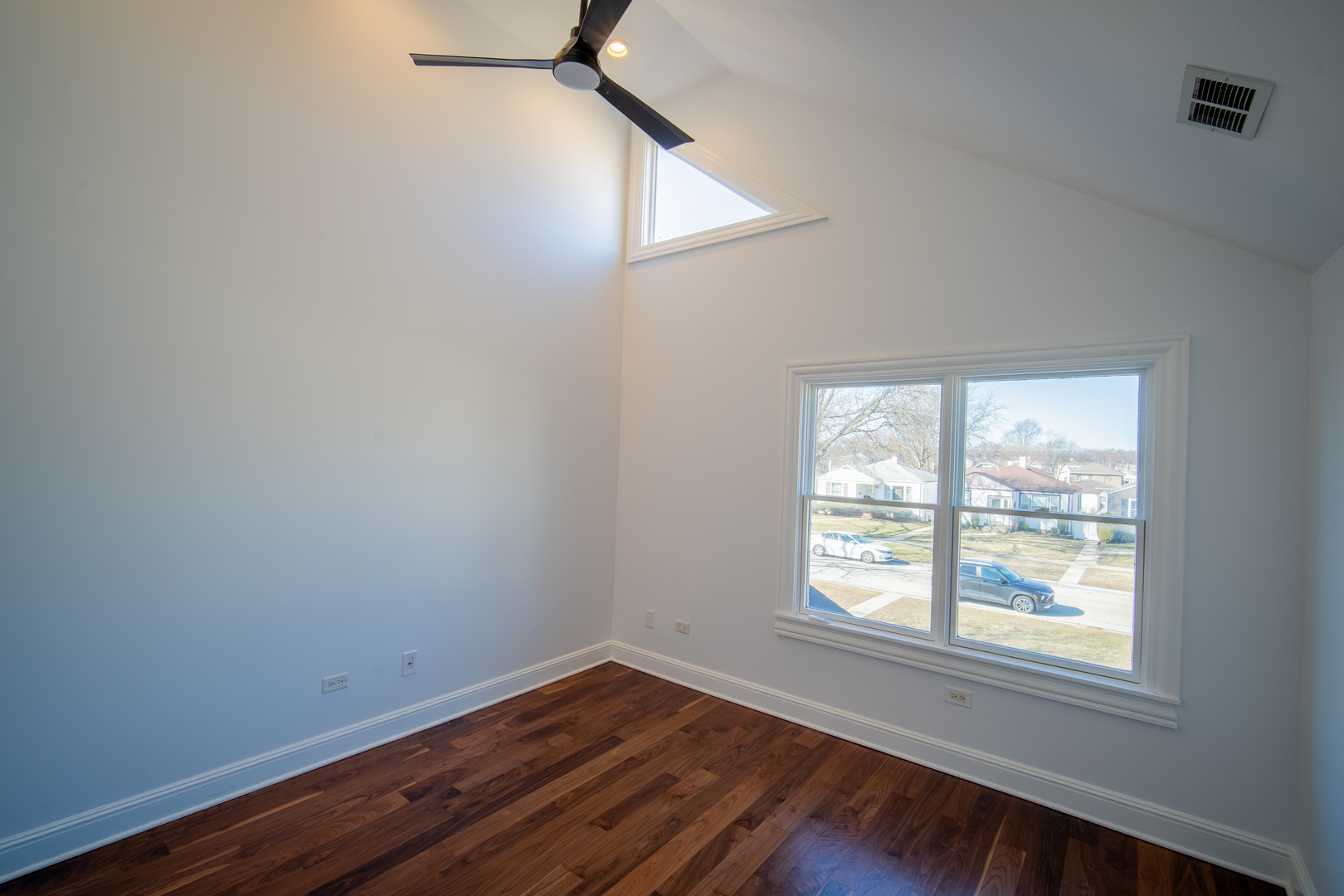 4137 Clinton Avenue Stickney, IL 60402 - Photo 31 of 41 an empty room with wooden floor and windows