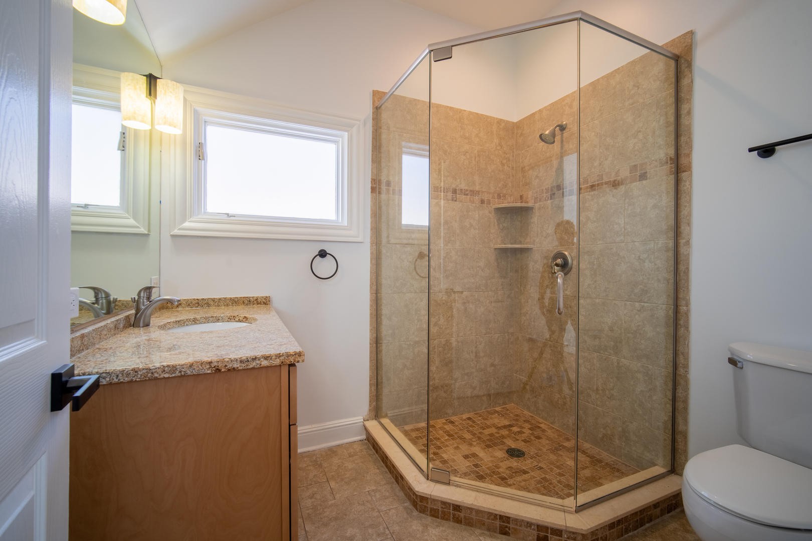 4137 Clinton Avenue Stickney, IL 60402 - Photo 32 of 41 a bathroom with a granite countertop sink a toilet and shower