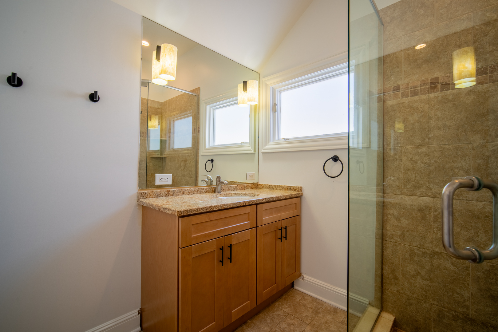 4137 Clinton Avenue Stickney, IL 60402 - Photo 33 of 41 a bathroom with a granite countertop sink a mirror and a shower
