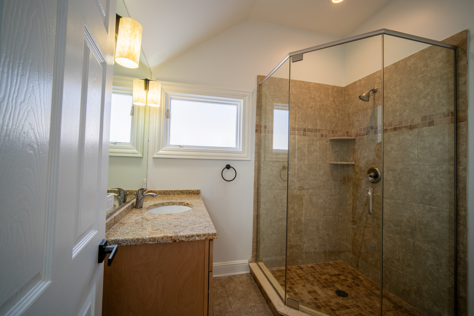 4137 Clinton Avenue Stickney, IL 60402 - Photo 34 of 41 a bathroom with a granite countertop sink a shower and a mirror