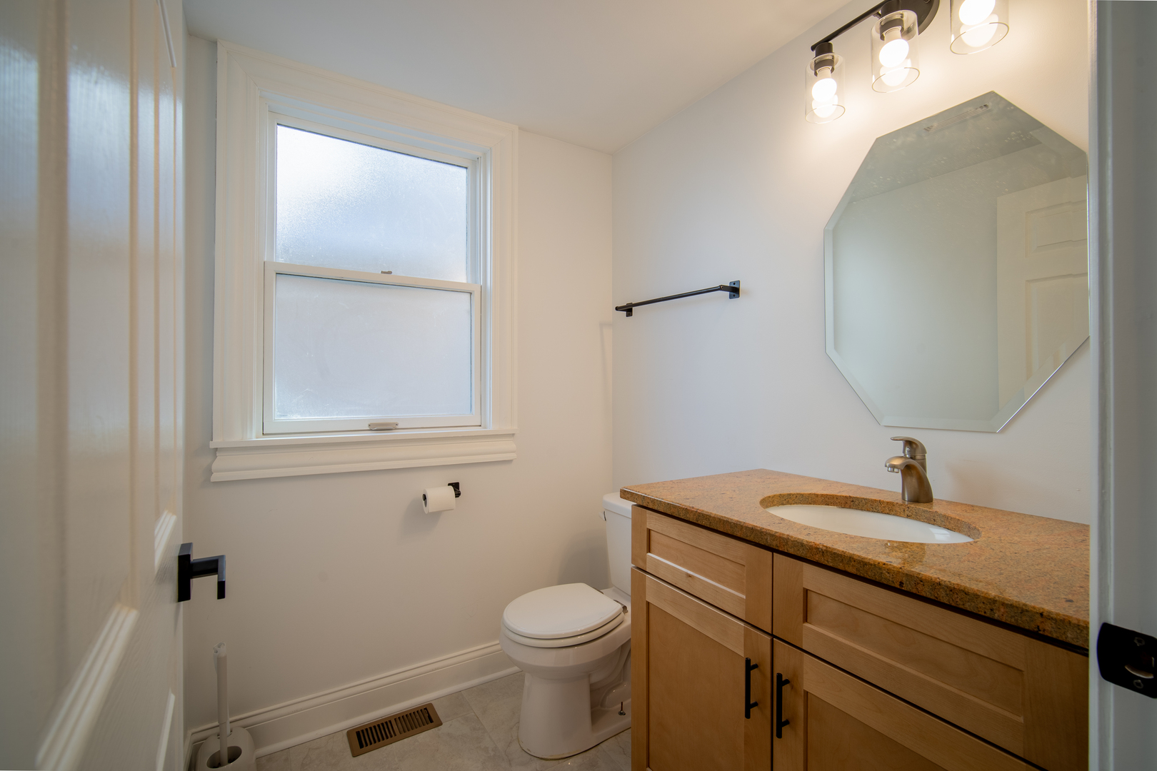 4137 Clinton Avenue Stickney, IL 60402 - Photo 37 of 41 a bathroom with a toilet a sink and mirror