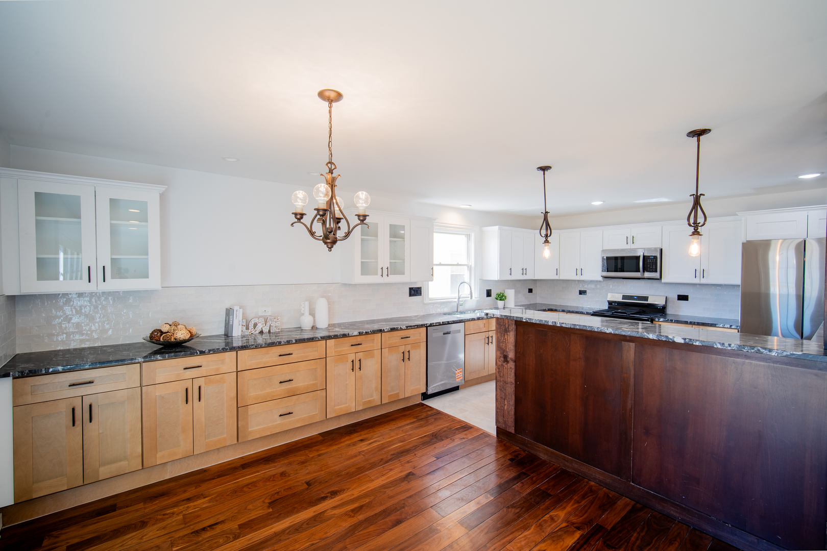 4137 Clinton Avenue Stickney, IL 60402 - Photo 5 of 41 a large kitchen with granite countertop a stove a sink and white cabinets with wooden floor