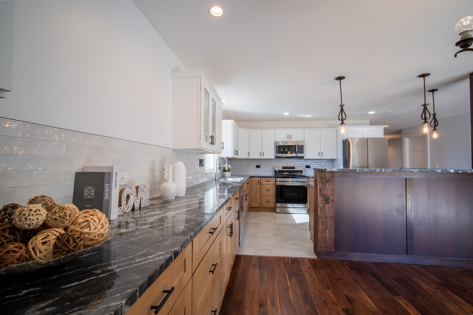 4137 Clinton Avenue Stickney, IL 60402 - Photo 6 of 41 a kitchen with kitchen island granite countertop wooden floors and stainless steel appliances