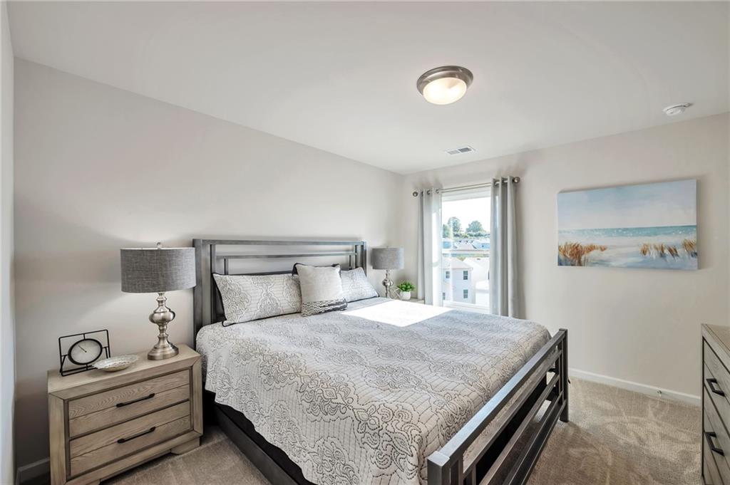 156 Millers Lane Calhoun, GA 30701 - Photo 22 of 26 a bedroom with a bed and a window