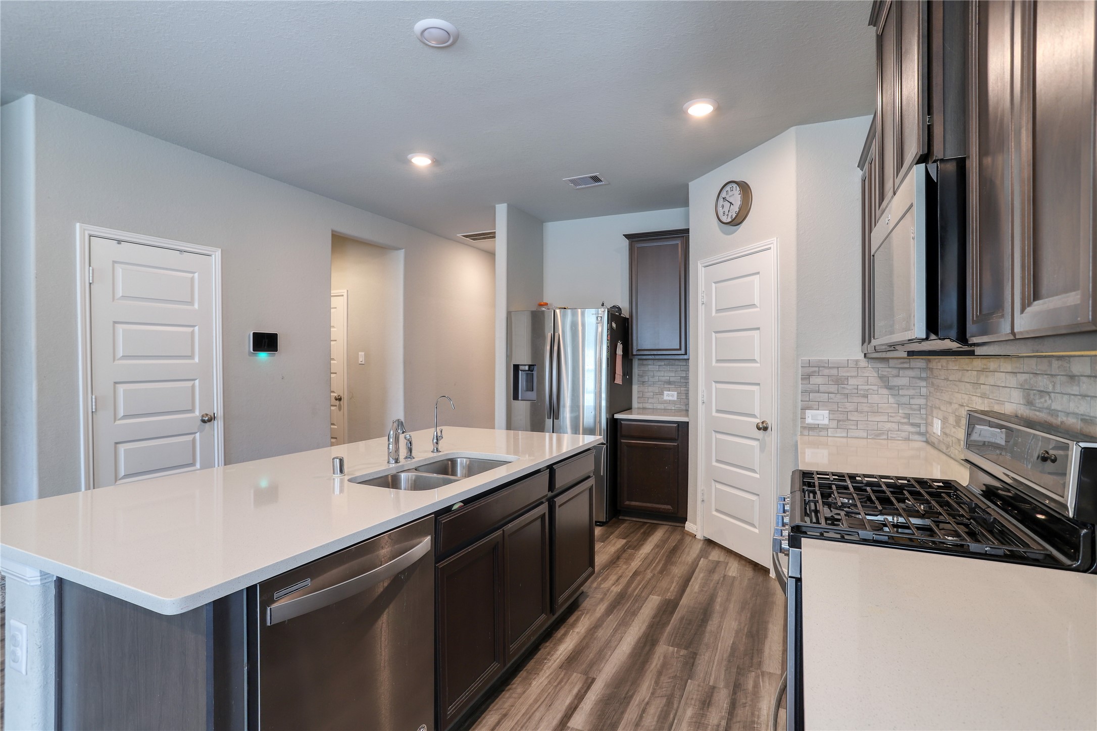 830 Modesto Drive Rosharon, TX 77583 - Photo 5 of 11 a kitchen with stainless steel appliances a sink stove and refrigerator