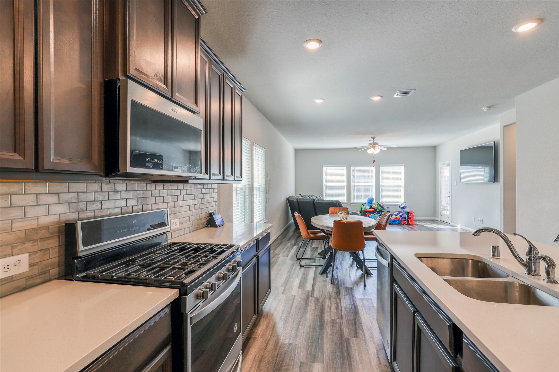 830 Modesto Drive Rosharon, TX 77583 - Photo 6 of 11 a kitchen with furniture wooden floor and stainless steel appliances