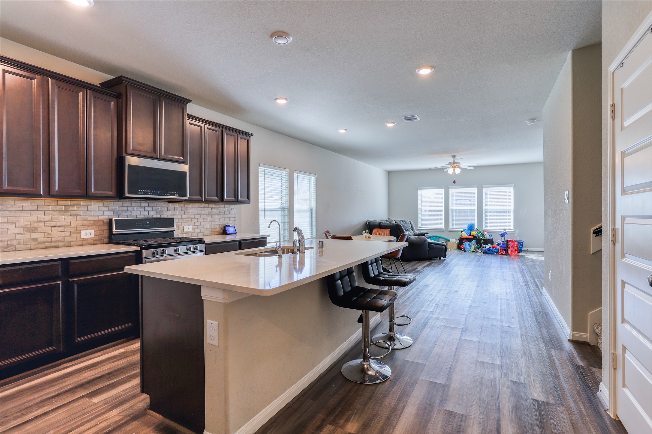 830 Modesto Drive Rosharon, TX 77583 - Photo 7 of 11 a kitchen with sink cabinets and wooden floor