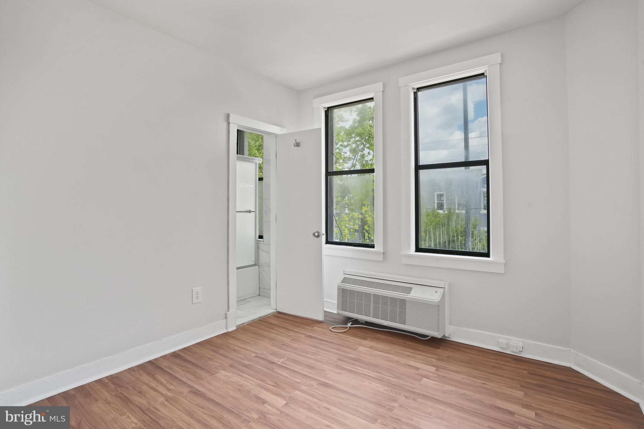 7 18th Street Southeast, Unit 208 Washington, DC 20003 - Photo 12 of 21 an empty room with wooden floor and windows