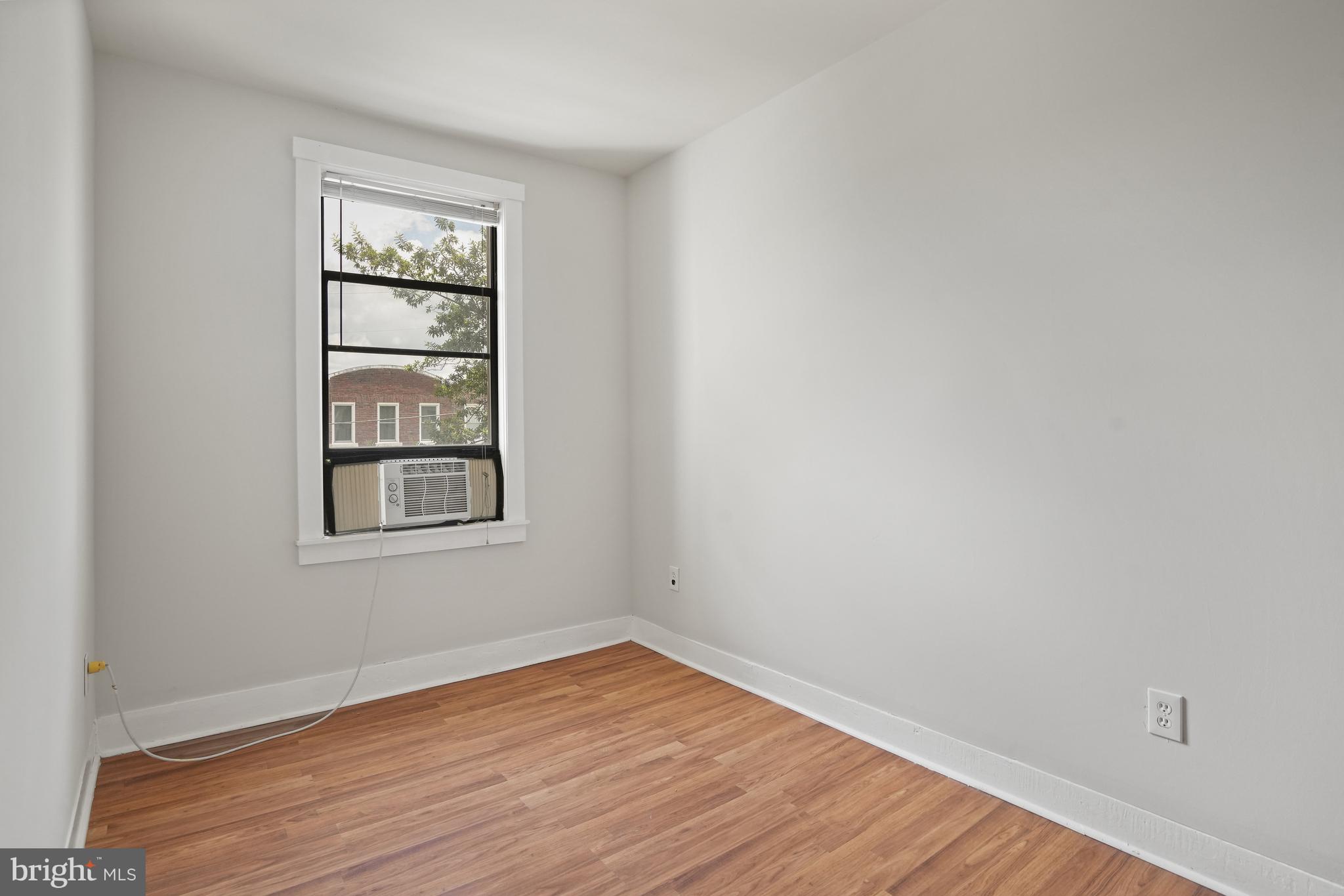 7 18th Street Southeast, Unit 208 Washington, DC 20003 - Photo 16 of 21 an empty room with wooden floor and windows
