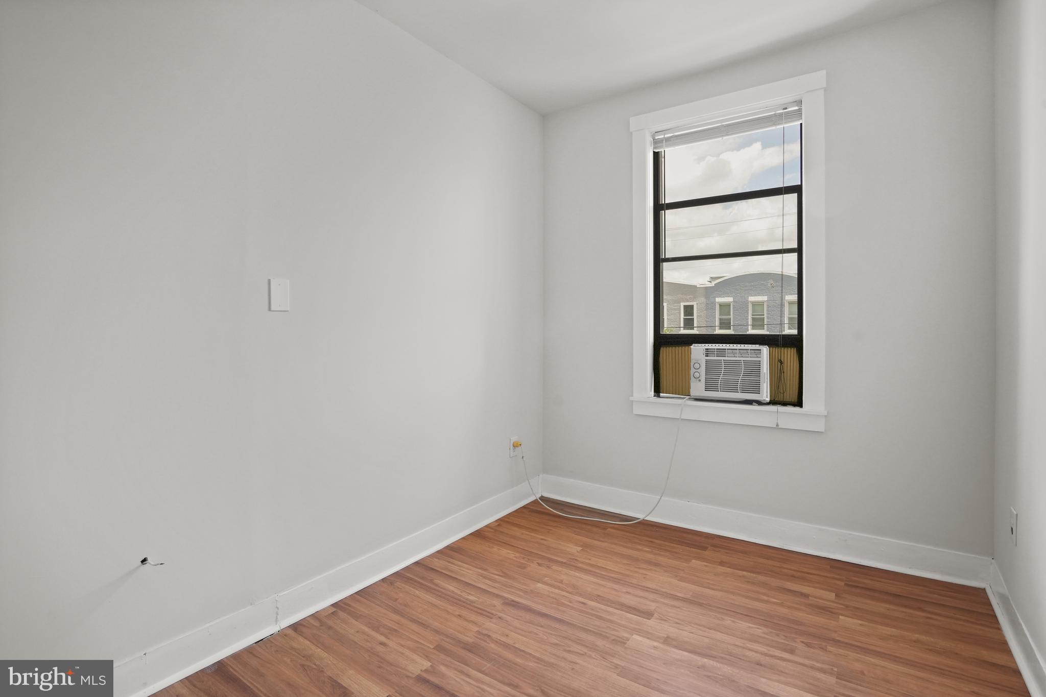 7 18th Street Southeast, Unit 208 Washington, DC 20003 - Photo 17 of 21 an empty room with wooden floor and windows
