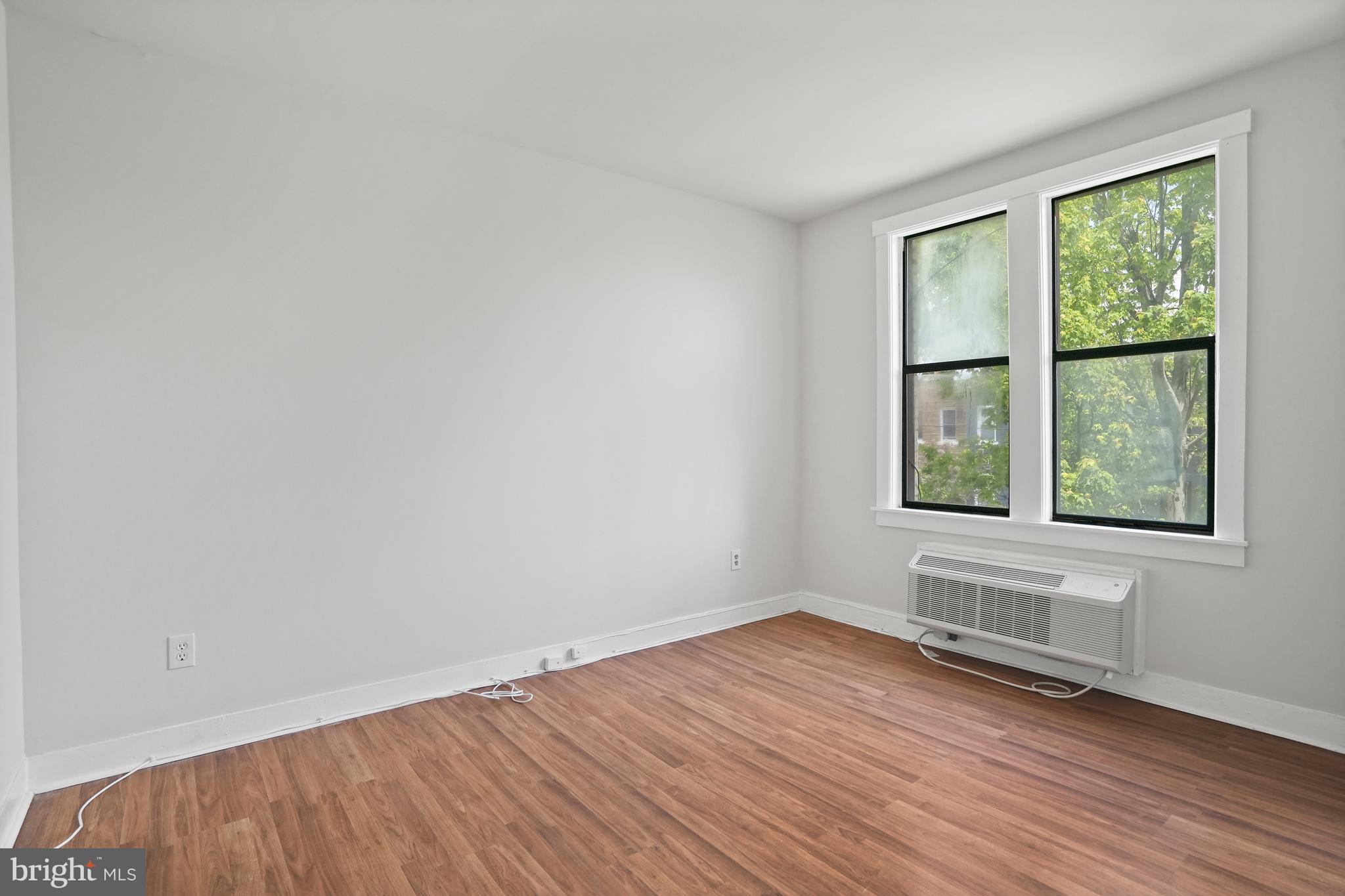 7 18th Street Southeast, Unit 208 Washington, DC 20003 - Photo 3 of 21 an empty room with wooden floor and windows
