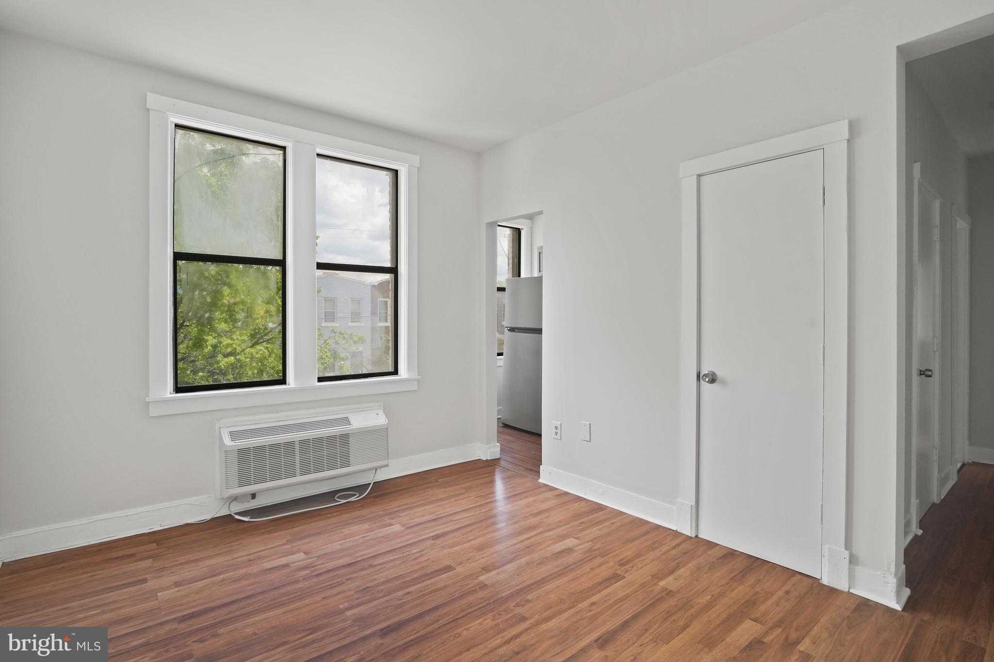 7 18th Street Southeast, Unit 208 Washington, DC 20003 - Photo 5 of 21 an empty room with wooden floor and windows