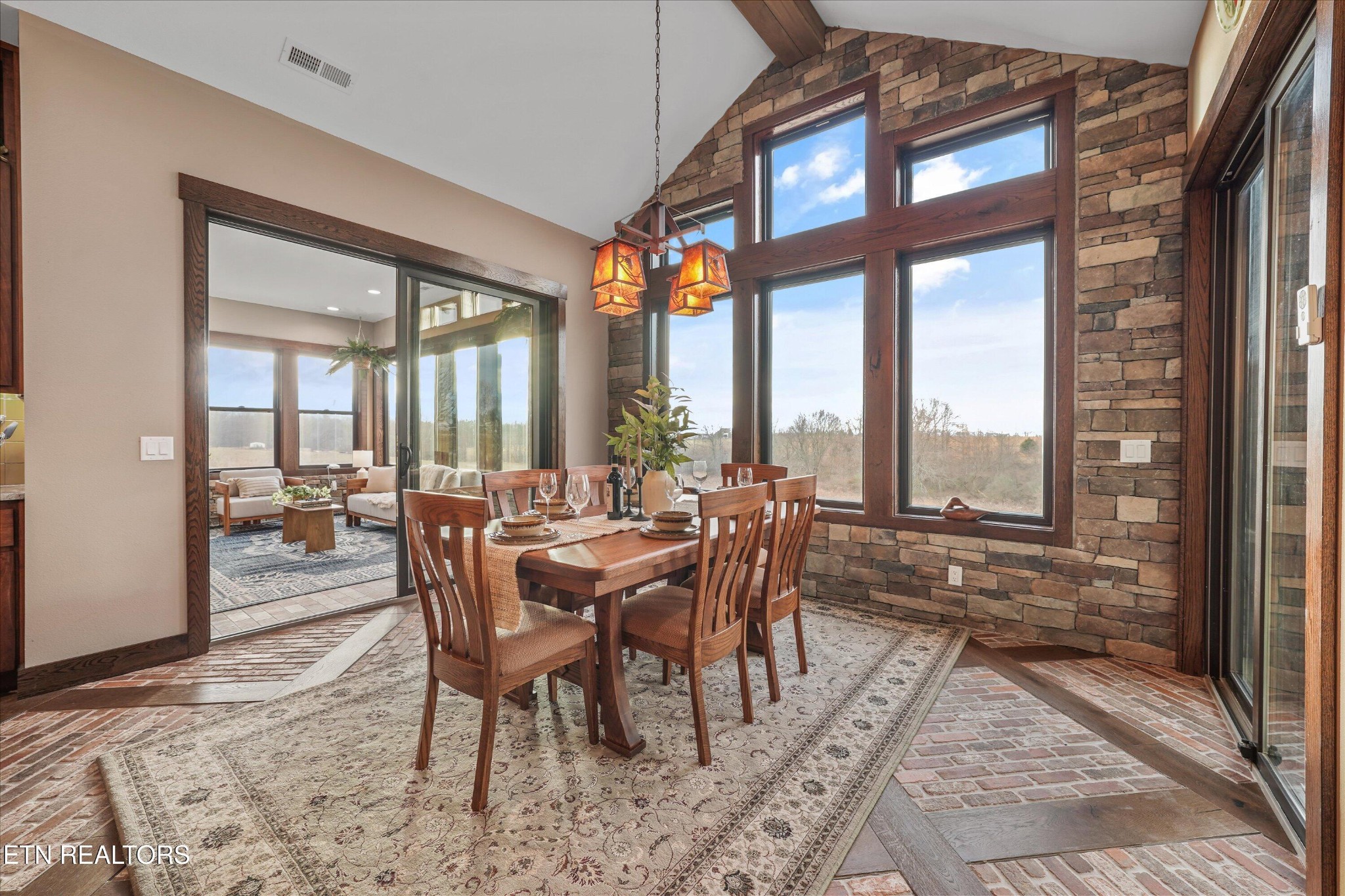 1150 Hillendale Road Crossville, TN 38572 - Photo 11 of 42 a view of a dining room with furniture large windows and wooden floor