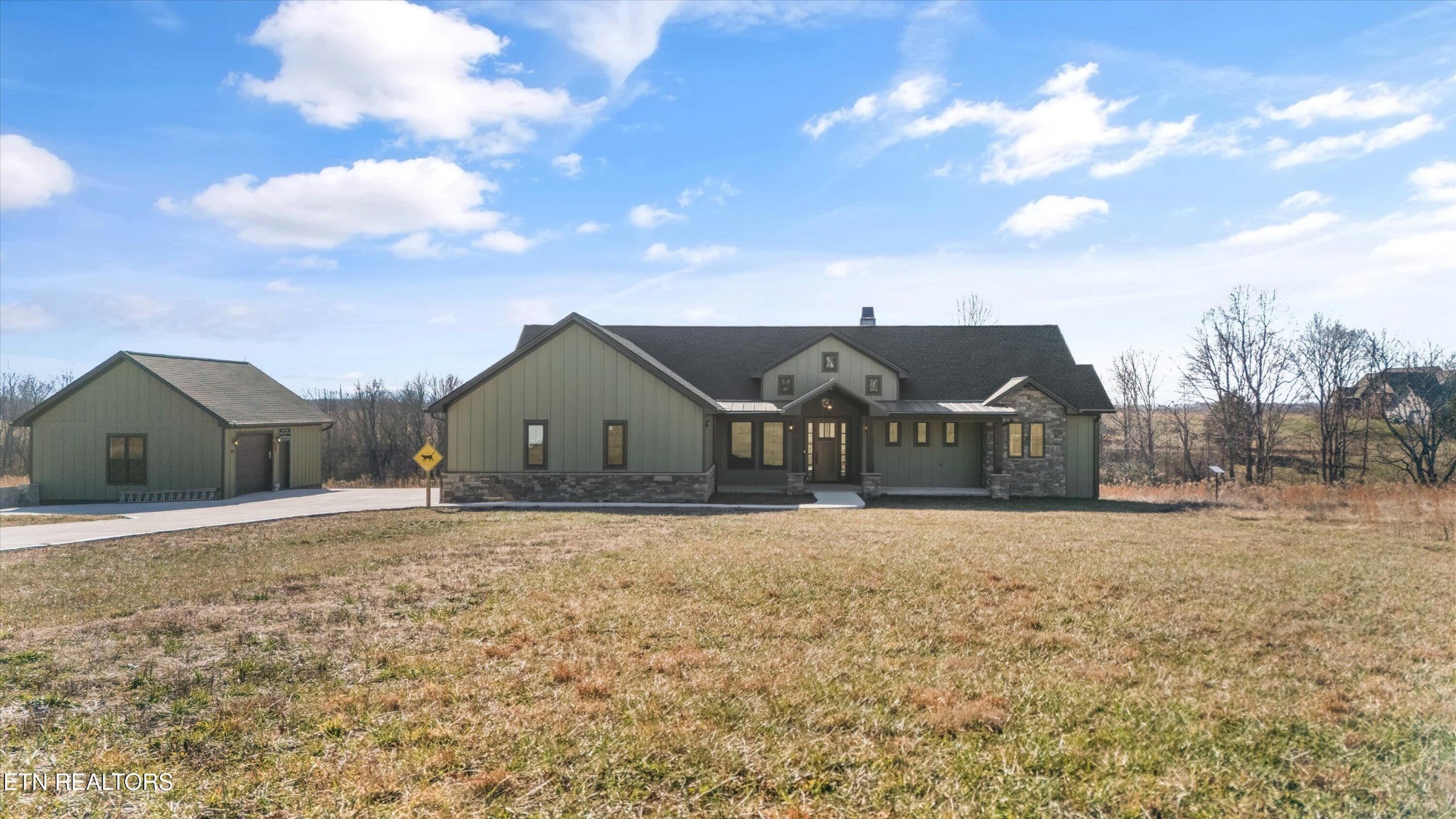 1150 Hillendale Road Crossville, TN 38572 - Photo 2 of 42 a front view of a house with a yard and garage