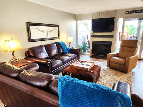 a living room with furniture flat screen tv and a fireplace