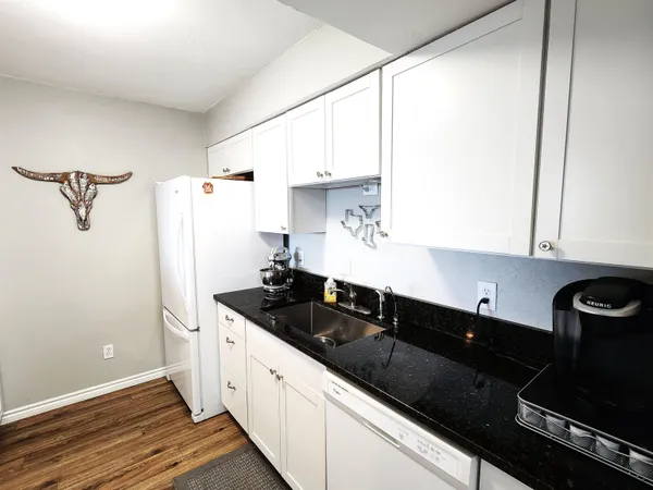 a kitchen with a sink and a refrigerator