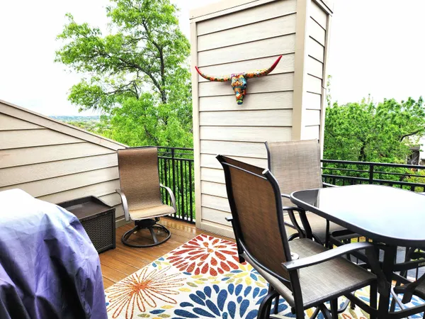 a balcony with table and chairs