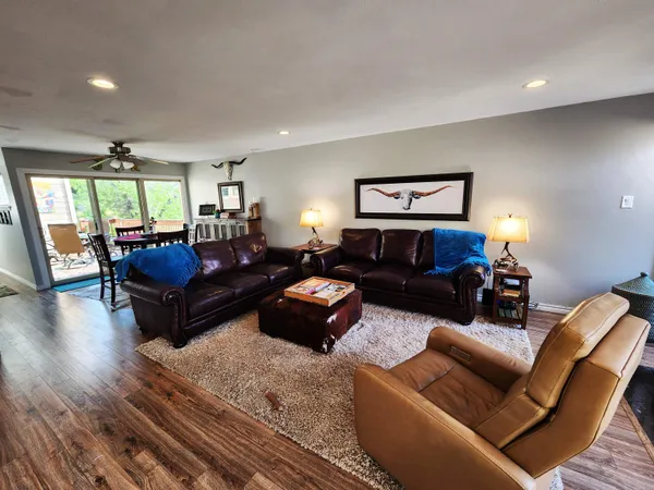a living room with furniture a window and a flat screen tv