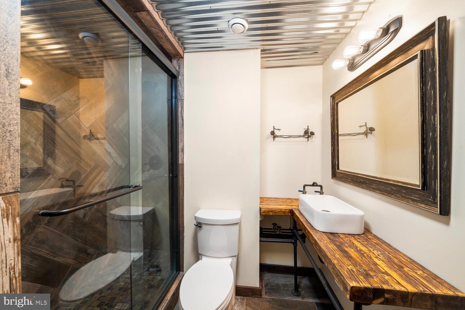 418 Oak Valley Road Media, PA 19063 - Photo 26 of 50 a bathroom with a sink a toilet a mirror and shower