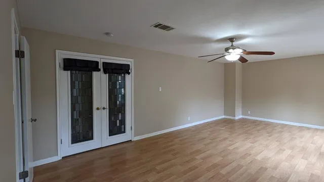 a view of a chandelier fan and entryway