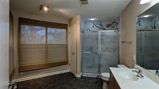 a bathroom with a shower and a sink