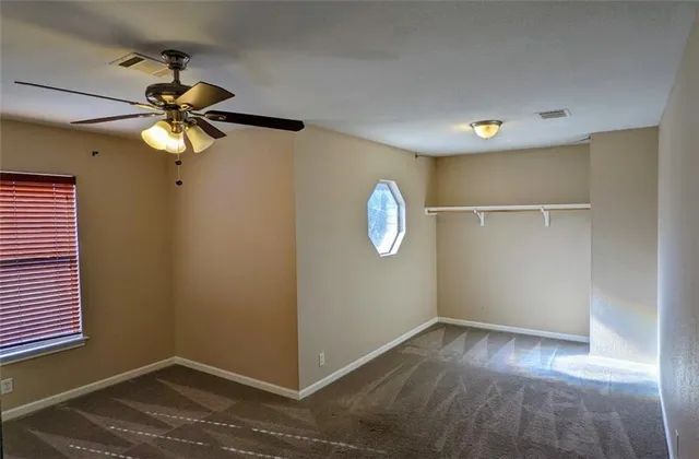 a view of room with window and ceiling fan