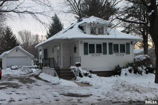 a view of a house with a yard covered in snow