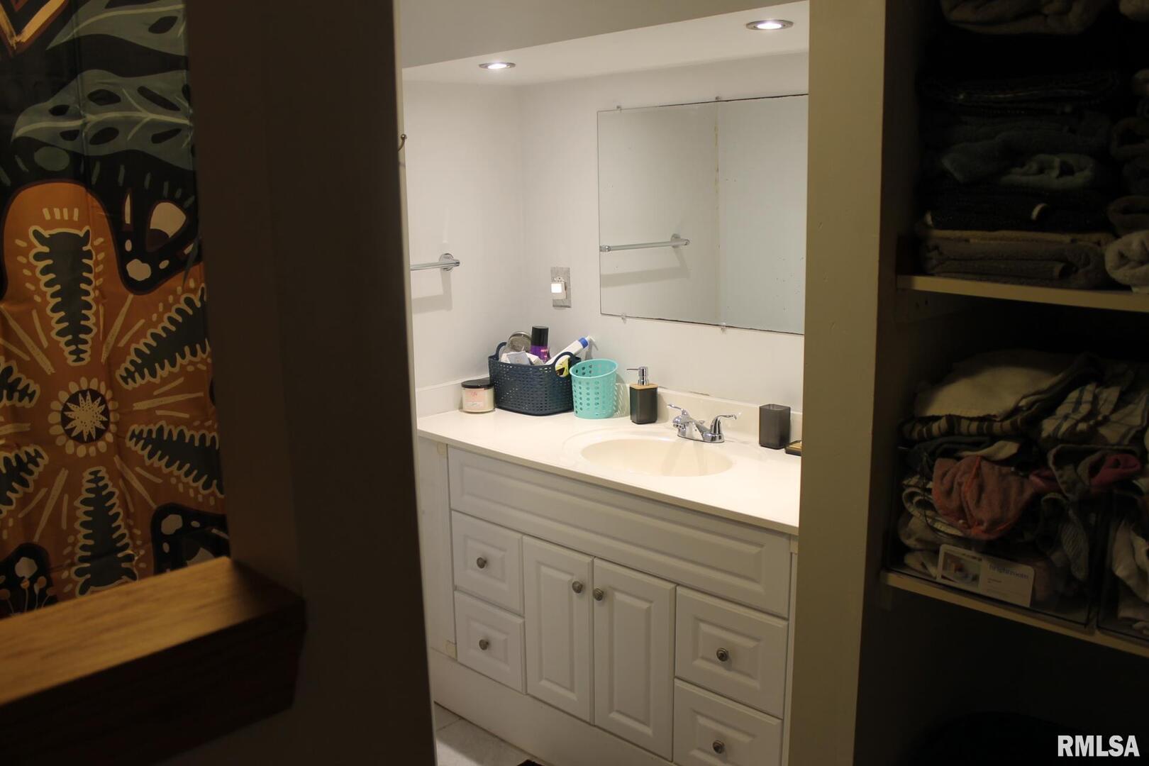 321 West South Street Cambridge, IL 61238 - Photo 12 of 26 a bathroom with a sink and a mirror