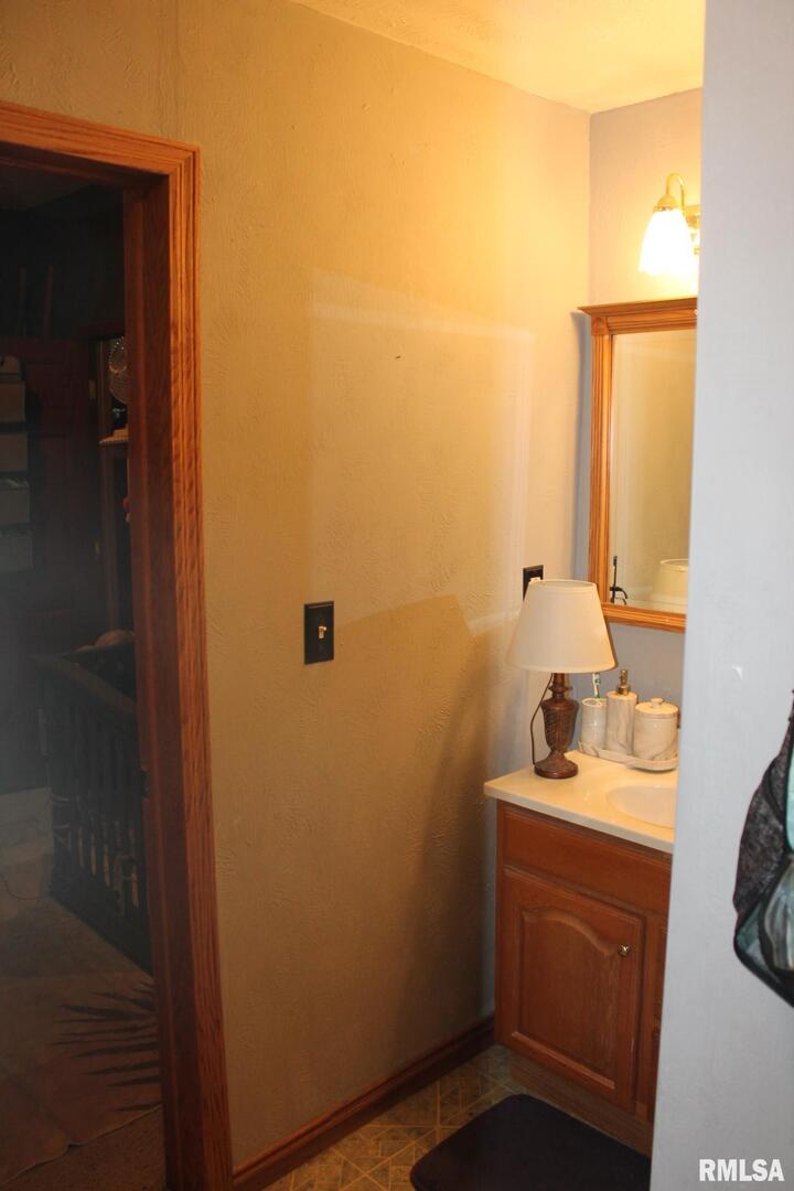321 West South Street Cambridge, IL 61238 - Photo 21 of 26 a bathroom with a sink vanity and a mirror