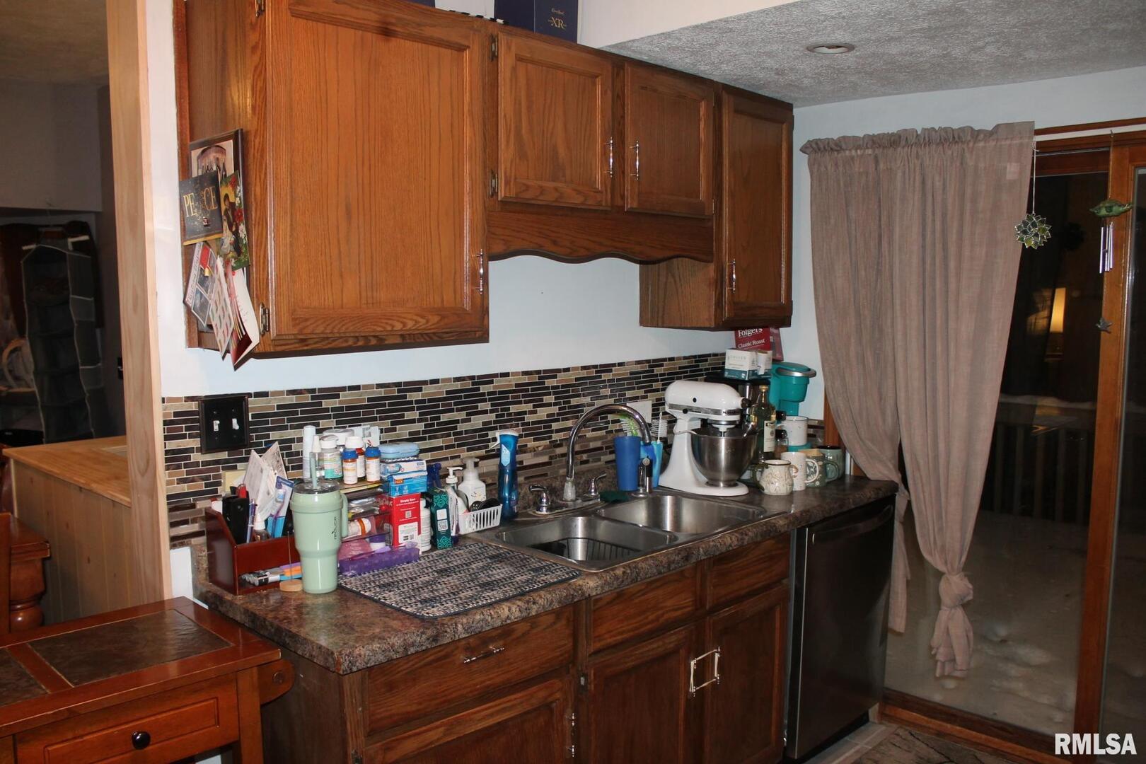 321 West South Street Cambridge, IL 61238 - Photo 25 of 26 a kitchen with stainless steel appliances granite countertop a sink a stove and a refrigerator