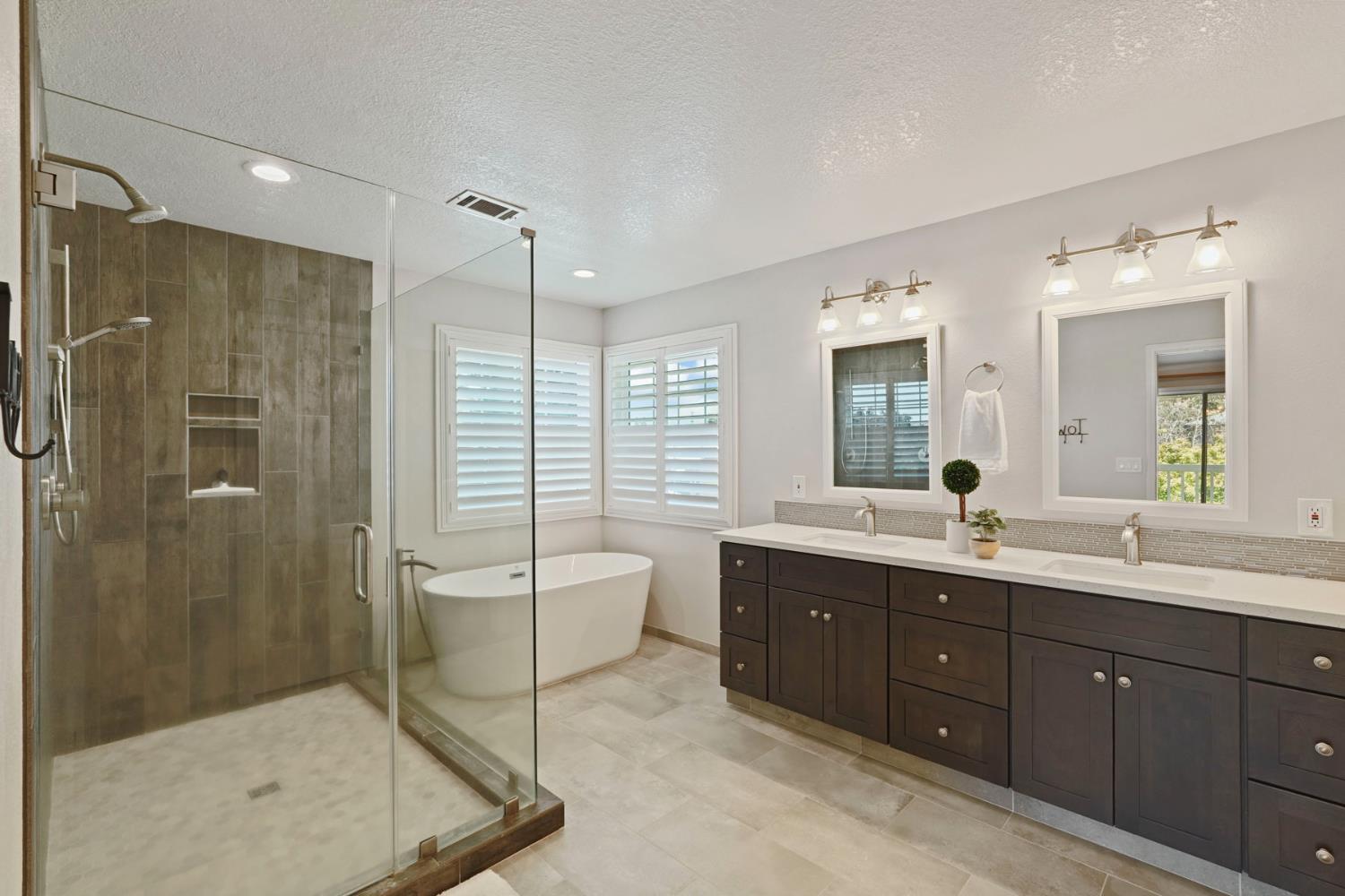 18432 Ironstone Street Woodbridge, CA 95258 - Photo 32 of 50 The remodeled bathroom with dual sinks, tub, shower and walk-in closet.