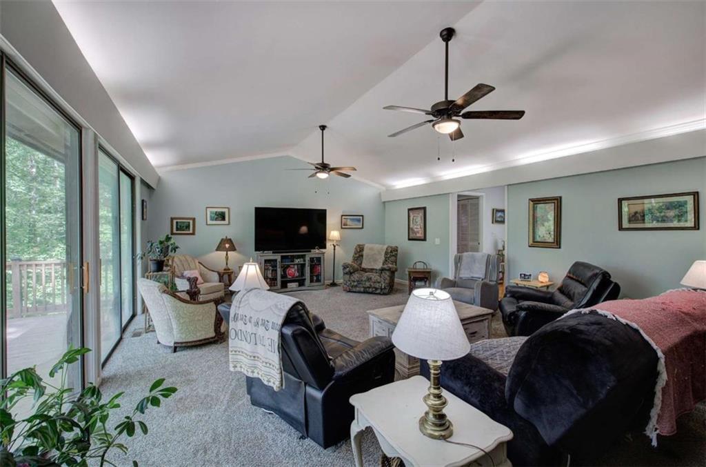 567 Fred Kelly Road Northeast Rome, GA 30161 - Photo 17 of 59 a living room with furniture a flat screen tv and a large window