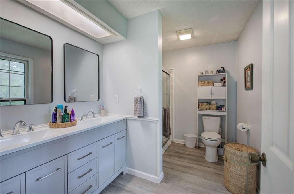 567 Fred Kelly Road Northeast Rome, GA 30161 - Photo 25 of 59 a bathroom with a double vanity sink toilet and shower