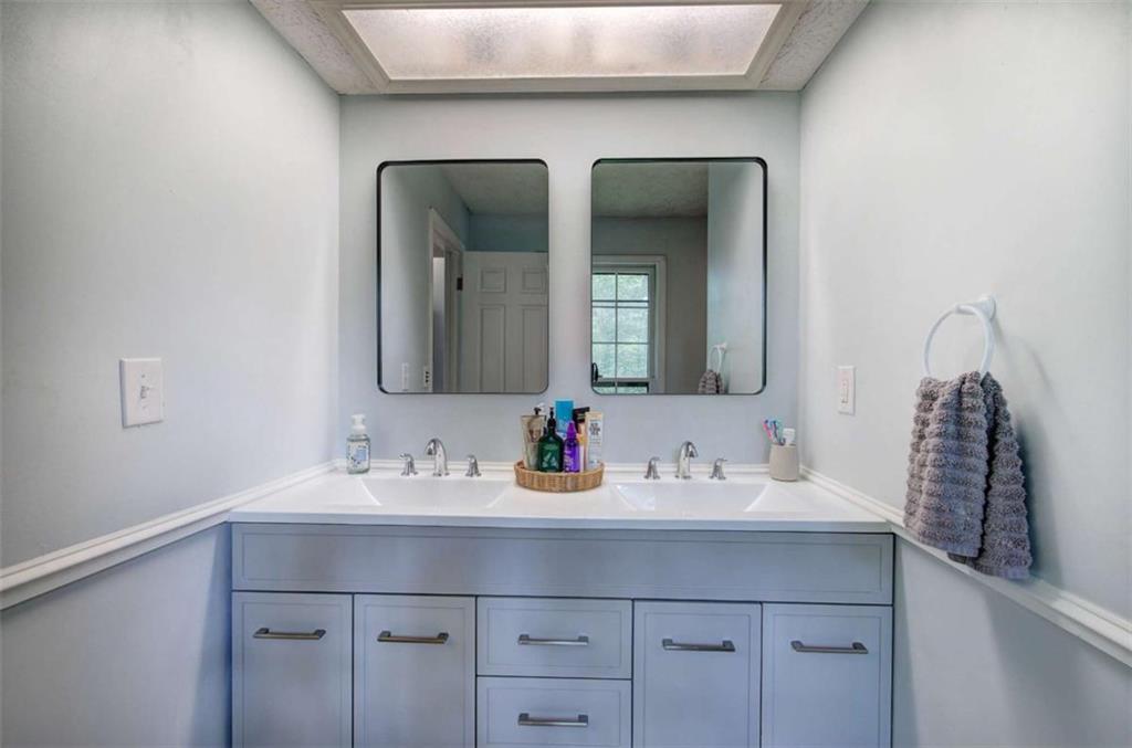 567 Fred Kelly Road Northeast Rome, GA 30161 - Photo 26 of 59 a bathroom with double vanity sinks and a mirror