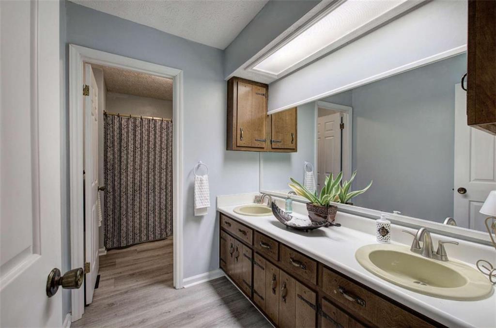 567 Fred Kelly Road Northeast Rome, GA 30161 - Photo 32 of 59 a bathroom with a double vanity sink and a mirror