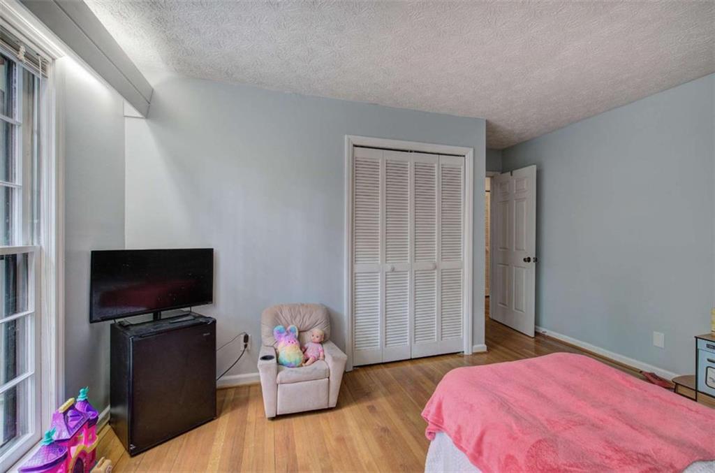 567 Fred Kelly Road Northeast Rome, GA 30161 - Photo 34 of 59 a bedroom with a bed and a flat screen tv