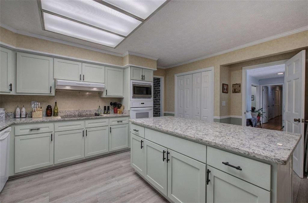 567 Fred Kelly Road Northeast Rome, GA 30161 - Photo 37 of 59 a kitchen with stainless steel appliances granite countertop a sink and cabinets