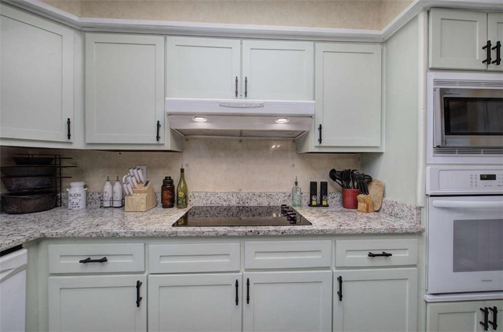 567 Fred Kelly Road Northeast Rome, GA 30161 - Photo 39 of 59 a kitchen with granite countertop white cabinets and a stove