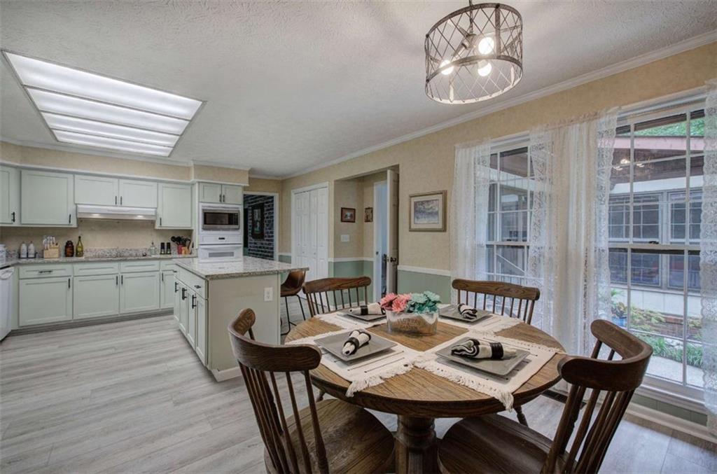 567 Fred Kelly Road Northeast Rome, GA 30161 - Photo 41 of 59 a open dining room with stainless steel appliances kitchen island granite countertop furniture and wooden floor