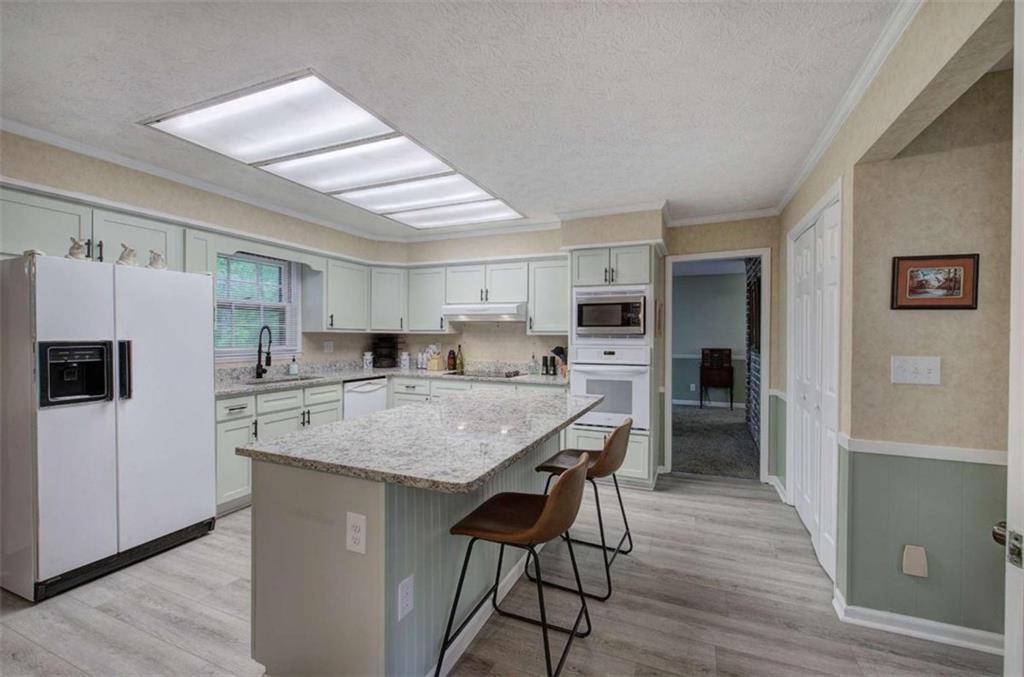 567 Fred Kelly Road Northeast Rome, GA 30161 - Photo 43 of 59 a kitchen with stainless steel appliances granite countertop a refrigerator and a stove top oven