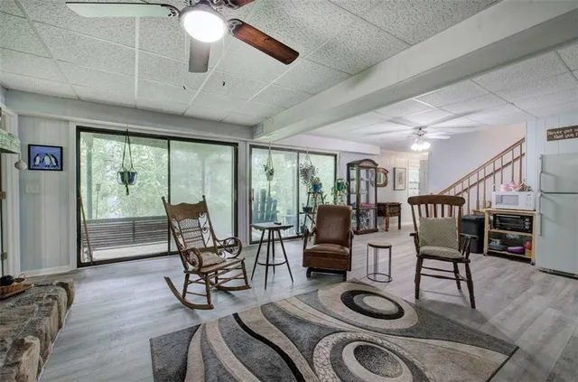 a kitchen with stainless steel appliances granite countertop table chairs sink and cabinets