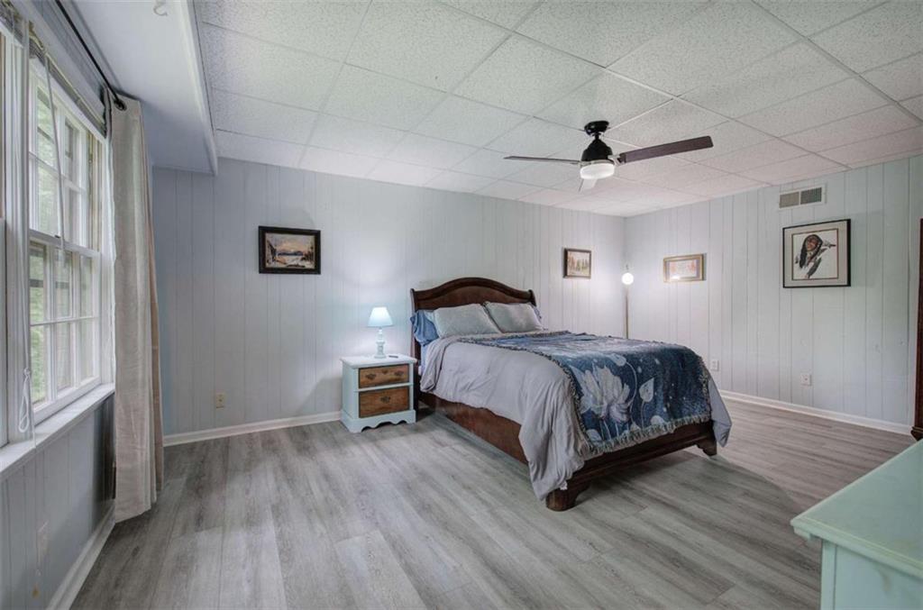 567 Fred Kelly Road Northeast Rome, GA 30161 - Photo 50 of 59 a bedroom with a bed lamp and a large window