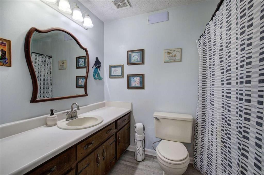 567 Fred Kelly Road Northeast Rome, GA 30161 - Photo 52 of 59 a bathroom with a toilet a sink and mirror